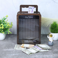 Wooden money box with digital display on a surface with scattered money and decorative items.